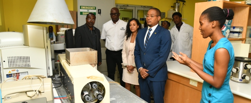 Minister of Agriculture, Fisheries and Mining Hon. Floyd Green (second left), looks on as Senior Veterinary Biochemical Analyst for the Ministry of Agriculture, Fisheries and Mining Veterinary Services Division, Georgette Thompson, highlights features of equipment used in the Division. Others (from left) are; Chief Veterinary Officer, Dr. Osbil Watson; Chief Technical Director in the Ministry, Orville Palmer; and Pan American Health Organization (PAHO)/ World Health Organization (WHO) Advisor, Health, Surve