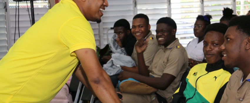 Minister of Agriculture, Fisheries and Mining, Hon. Floyd Green (left) interacts with youngsters during the national 'Eat Jamaica Day' ceremony at the College of Agriculture, Science and Education (CASE) in Portland on Friday (November 24).
