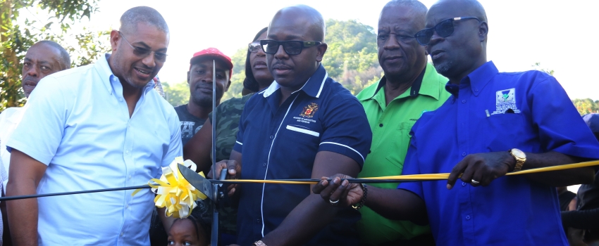 Minister of Agriculture and Fisheries, Pearnel Charles Jr cuts the ribbon to the Back Street farm road