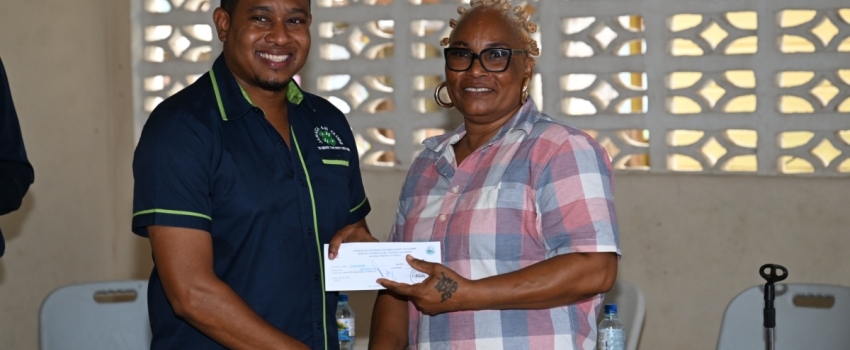 Minister of Agriculture, Fisheries and Mining, Hon. Floyd Green, presents a cash voucher to fisher, Lillian Brown, during the National Fisheries Authority’s (NFA) post- Hurricane Beryl relief programme in Whitehouse, Westmoreland, on Friday (August 30). Fisherfolk sustaining losses during the hurricane’s passage on July 3, received cash vouchers.