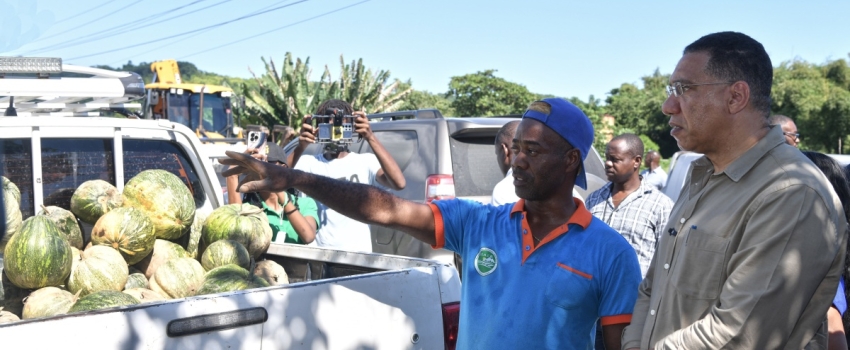 Prime Minister, the Most Hon. Andrew Holness (right) is in conversation with St. Thomas farmer, Garfield Espeut, during a tour of sections of the parish today (November 19), to look at the effects of the recent heavy rains.