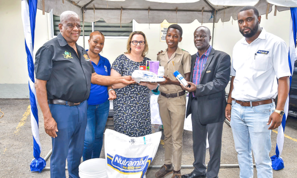 Minister of State in the Ministry of Agriculture and Fisheries, Hon. Franklin Witter (left); High Commissioner of Canada to Jamaica, Her Excellency Emina Tudakovic (third left); and Acting Chief Executive Officer of the Rural Agricultural Development Authority (RADA), Winston Simpson (second right), present supplies to 15-year-old small ruminant farmer and Oberlin High School student, Kaheim McLune (third right). The items, donated by Nutramix, were handed over to farmers participating in an ‘Internal and E