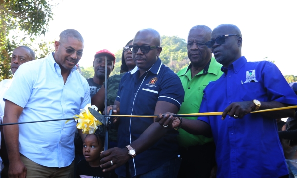 Minister of Agriculture and Fisheries, Pearnel Charles Jr cuts the ribbon to the Back Street farm road