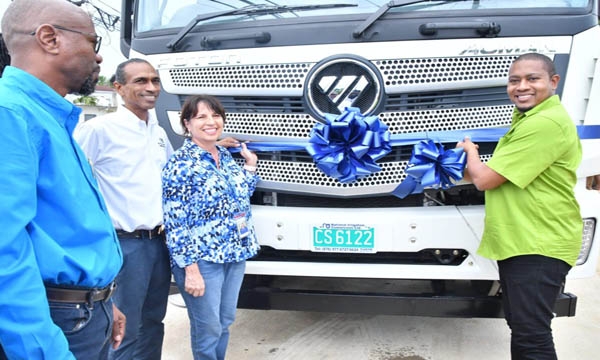 Minister of Agriculture, Fisheries and Mining, Hon. Floyd Green (right) cuts the ribbon to officially hand over a water truck on Clarks Town, Trelawny. Occasion was a commissioning ceremony for the truck, a ramp and pumping station on Thursday, October 5. Sharing the moment are (from left) Chief Executive Officer at the National Irrigation Commission  (NIC), Joseph Gyles, Chairman of the NIC Board, Nigel Myrie and Board Member at the NIC, Genille Attalla.