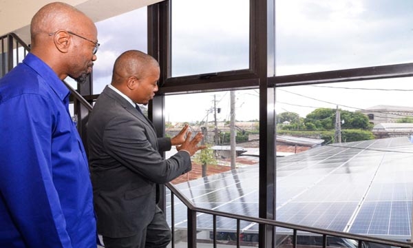 Minister of Agriculture, Fisheries and Mining, Hon. Floyd Green (right) and Chief Executive Officer, National Irrigation Commission (NIC), Joseph Gyles, examine the 30-kilowatt grid-type solar system installed at the NIC's expanded Operations Centre and Rio Cobre office in St. Catherine, during a commissioning ceremony at the facility on Wednesday (September 13).